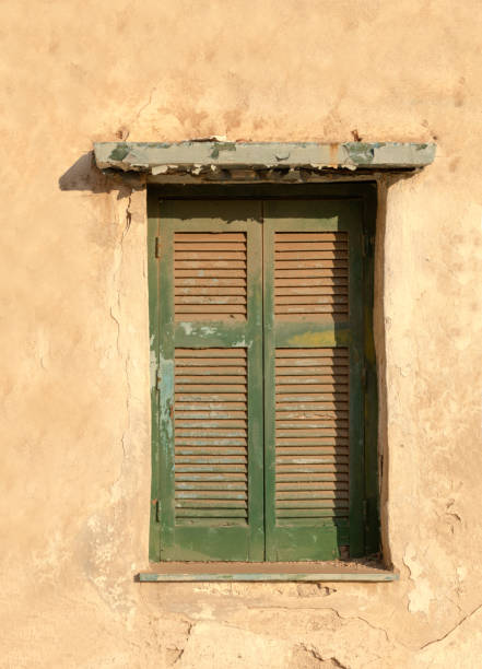 istock Old wooden window on grunge weathered wall. 1260492981