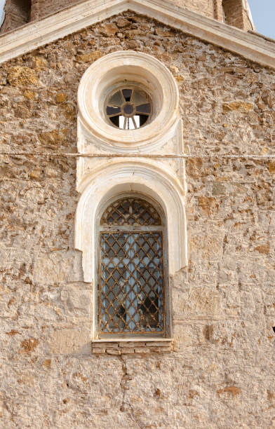 istock Window detail of a small old stone temple 1260492995
