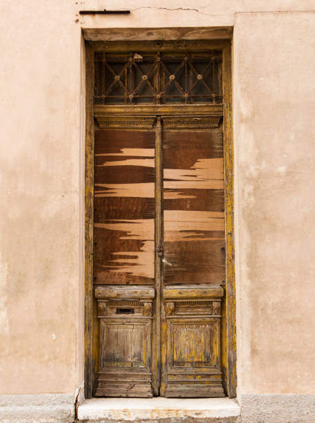 istock Old wooden door on grunge weathered wall. 1260493000