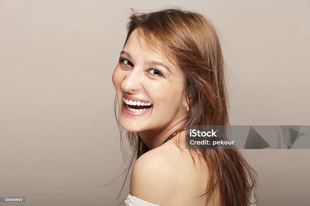 Portrait of laughing redhead woman turning around Portrait of laughing redhead woman turning around on gradient background Laughing Stock Photo