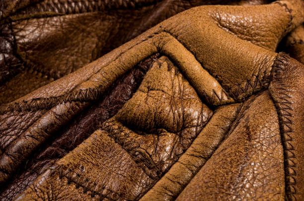 istock Old vintage genuine soft brown leather texture background, top layer with pores and scratches, macro, close-up 1260505607