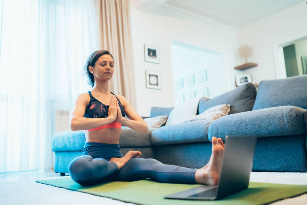istock Woman practicing yoga at home 1260515598