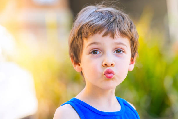 istock Little boy looking at the camera puckering 1260522863