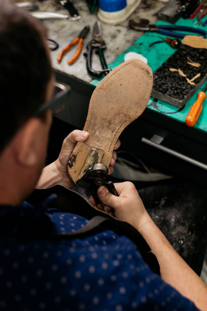 istock Cobbler repairing shoe 1260554496