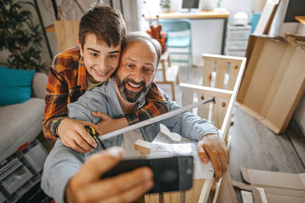 istock Father and son taking selfie at home 1260576182