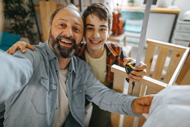 Father and son taking selfie at home