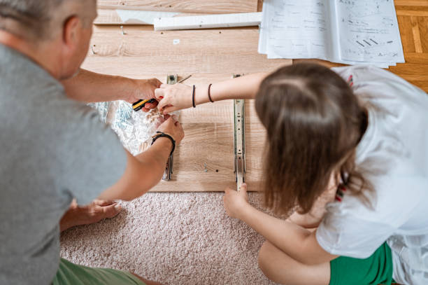 istock Father and daughter assembling a new furniture 1260585640