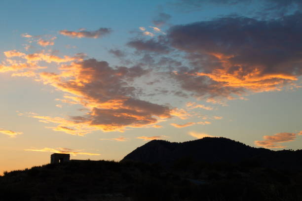 Spectacular twilight with the sun hidden in the clouds on a summer night