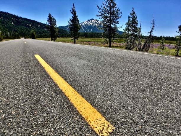 istock down the road towards a snowcapped mountain 1260600827