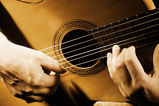 Guitar music art. Guitar music art. String guitarist playing. Details of acoustic musical instrument with performer hands chamber orchestra stock pictures, royalty-free photos & images