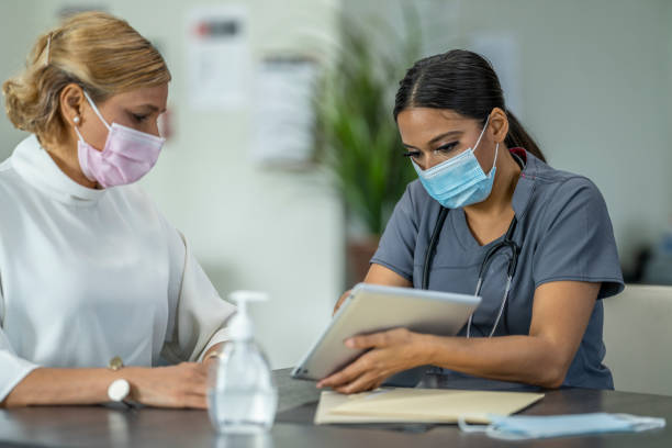 istock Masked Medical Appointment 1260644039