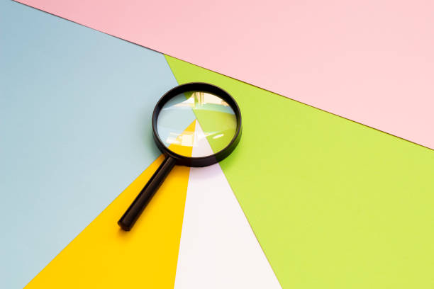 istock Magnifying glass against colorful pastel background flat lay minimal creative concept. 1260645113
