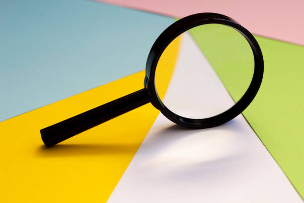 istock Magnifying glass against colorful pastel background. 1260647261