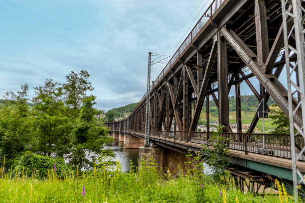 istock old iron bridge spans river Moselle, bridge is called Canon bridge and serves sicne the 17th century for trains and cars 1260650409