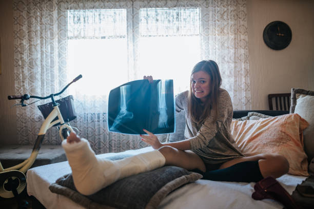 istock Disabled woman with broken leg and plaster foot at home 1260651055