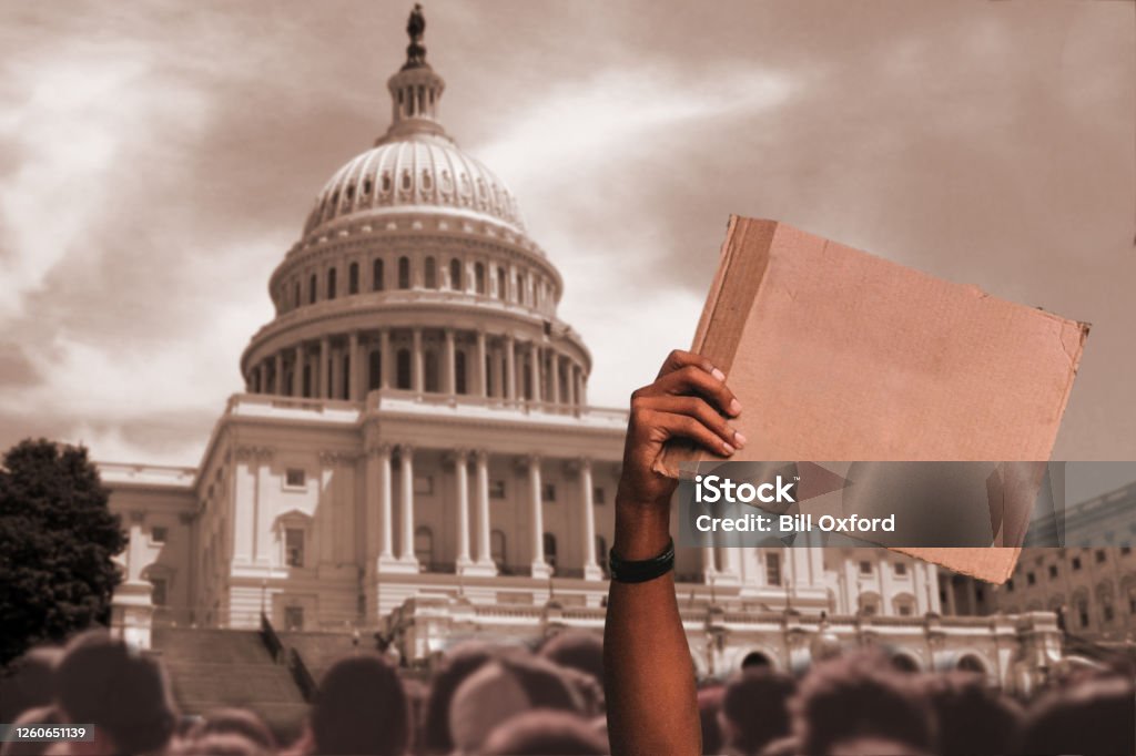 Blank sign at Protest at city street with man holding sign in crowd by Capitol Building Washington DC Racism Stock Photo