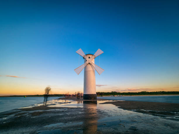 An old lighthouse in Swinoujscie, Poland at dusk.