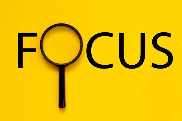 istock FOCUS Word with Magnifying Glass on colored background 1260678925
