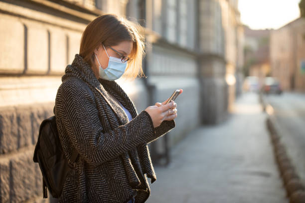 istock Young woman with mask and mobile 1260693031