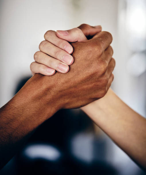 Multi Race Hands Joined Together Multi-race hands embracing in a show of unity. social inclusion photos stock pictures, royalty-free photos & images