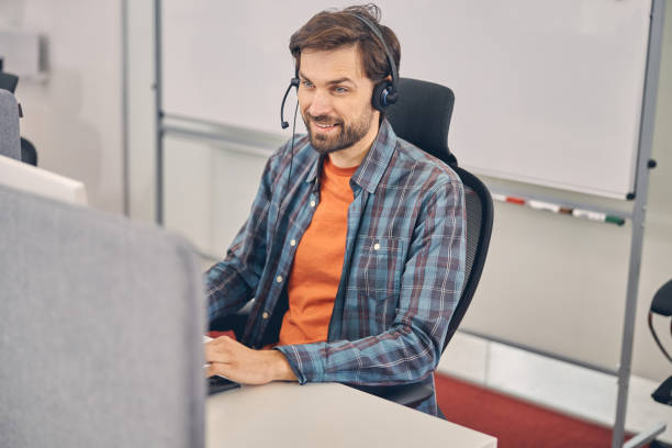 istock Cheerful young man working in modern office 1260700293