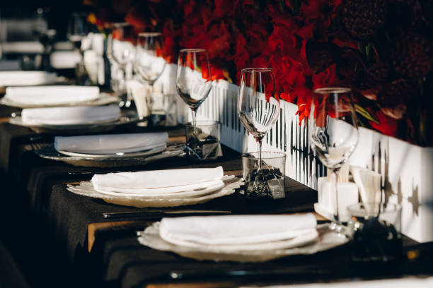 istock tableware Glasses, flower fork, knife served for dinner in restaurant with cozy interior 1260715330