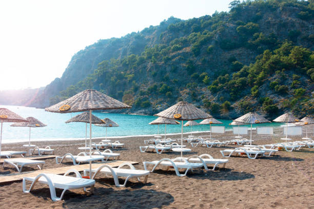 istock Beach chairs with umbrellas and beautiful sand beach 1260725285
