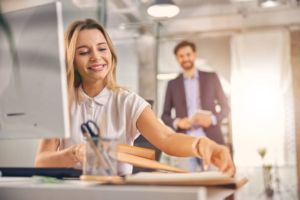 istock Charming young woman working in modern office 1260734119