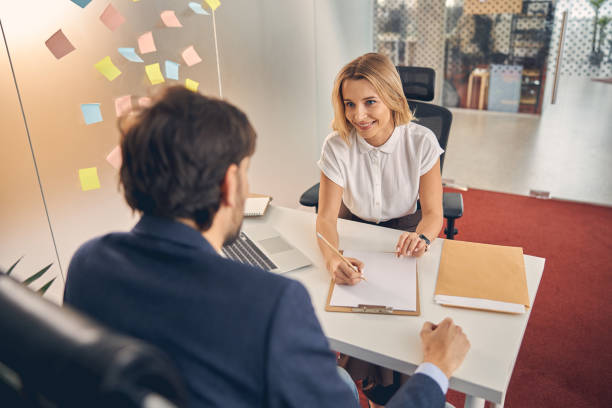 istock Charming young woman having meeting with client in office 1260734632