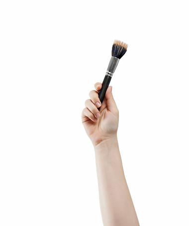 Woman holding a make up brush