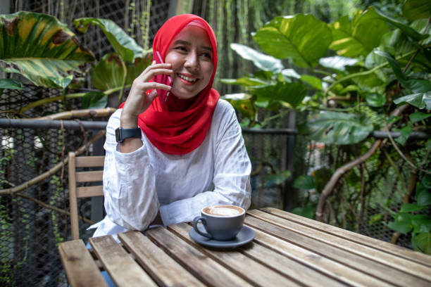 istock Asian women talking and using phone 1260739840