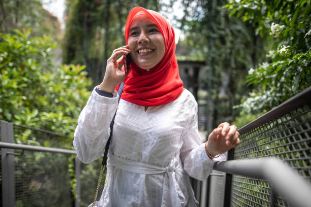 istock Asian women talking and using phone 1260739848