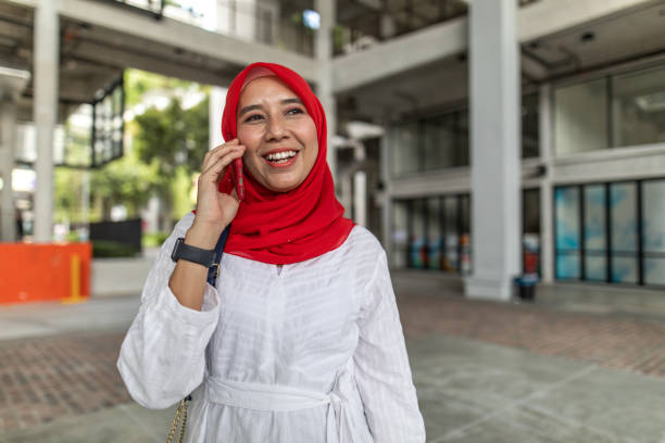 istock Asian women talking and using phone 1260740897
