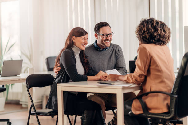 Couple talking to their insurance agent on a meeting stock photo