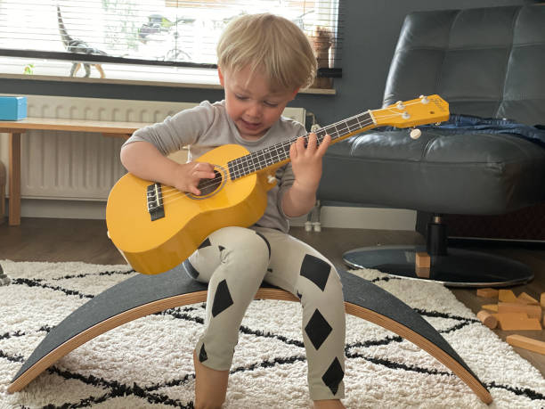 istock Toddler boy playing his toy guitar 1260775503