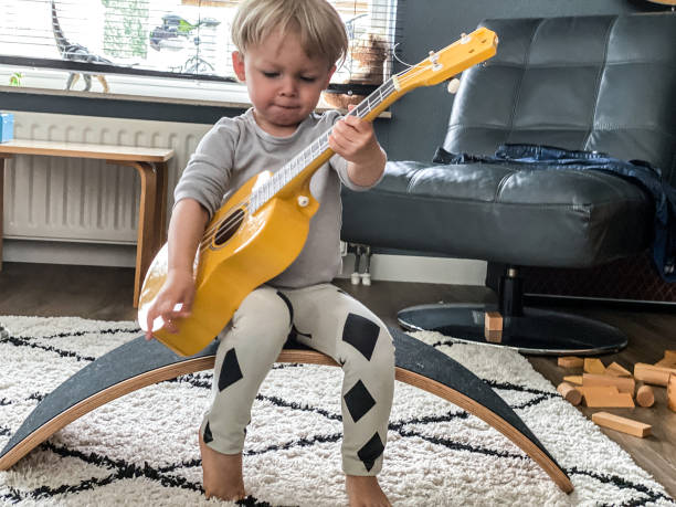 istock Toddler boy playing his toy guitar 1260775504