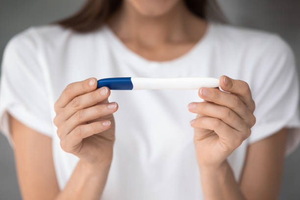 istock Close up view female hands holding pregnancy or ovulation test 1260812576