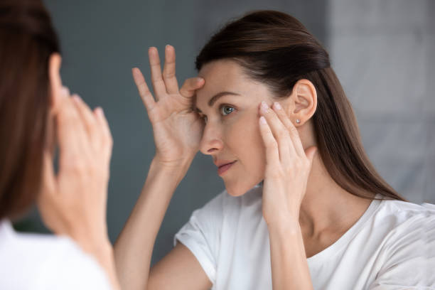 istock Satisfied woman looking in mirror check face after beauty treatment 1260813106