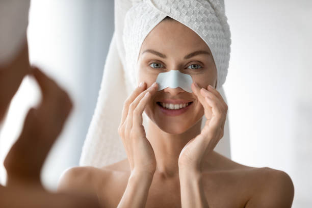 istock Woman using deep cleansing pore nasal strips anti blackheads treatment 1260813124