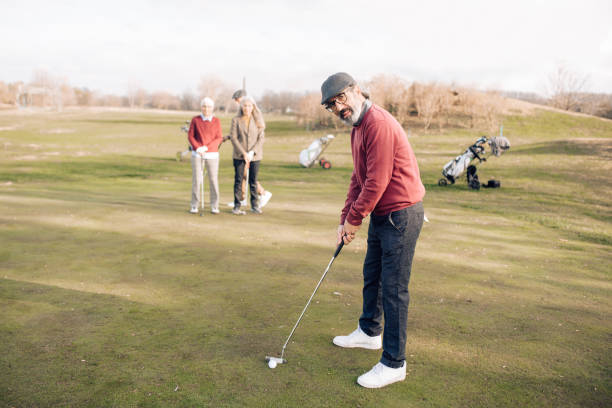istock Senior man playing golf with his old friends 1260814188