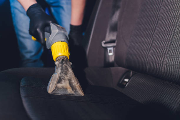 istock Car interior textile seats chemical cleaning with professionally extraction method. Early spring cleaning or regular clean up. 1260817989