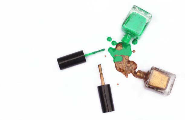 istock Green and Gold Nail polish Spilled on White 1260876269