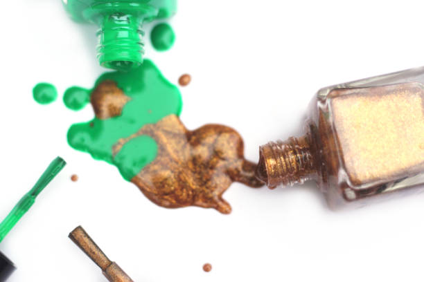 istock Green and Gold Nail polish Spilled on White 1260876305