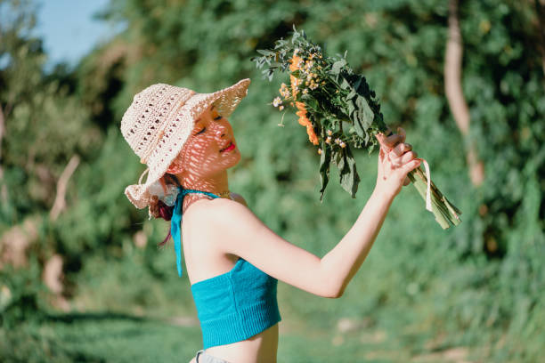 natural beauty girl with bouquet of flowers outdoor in freedom enjoyment concept