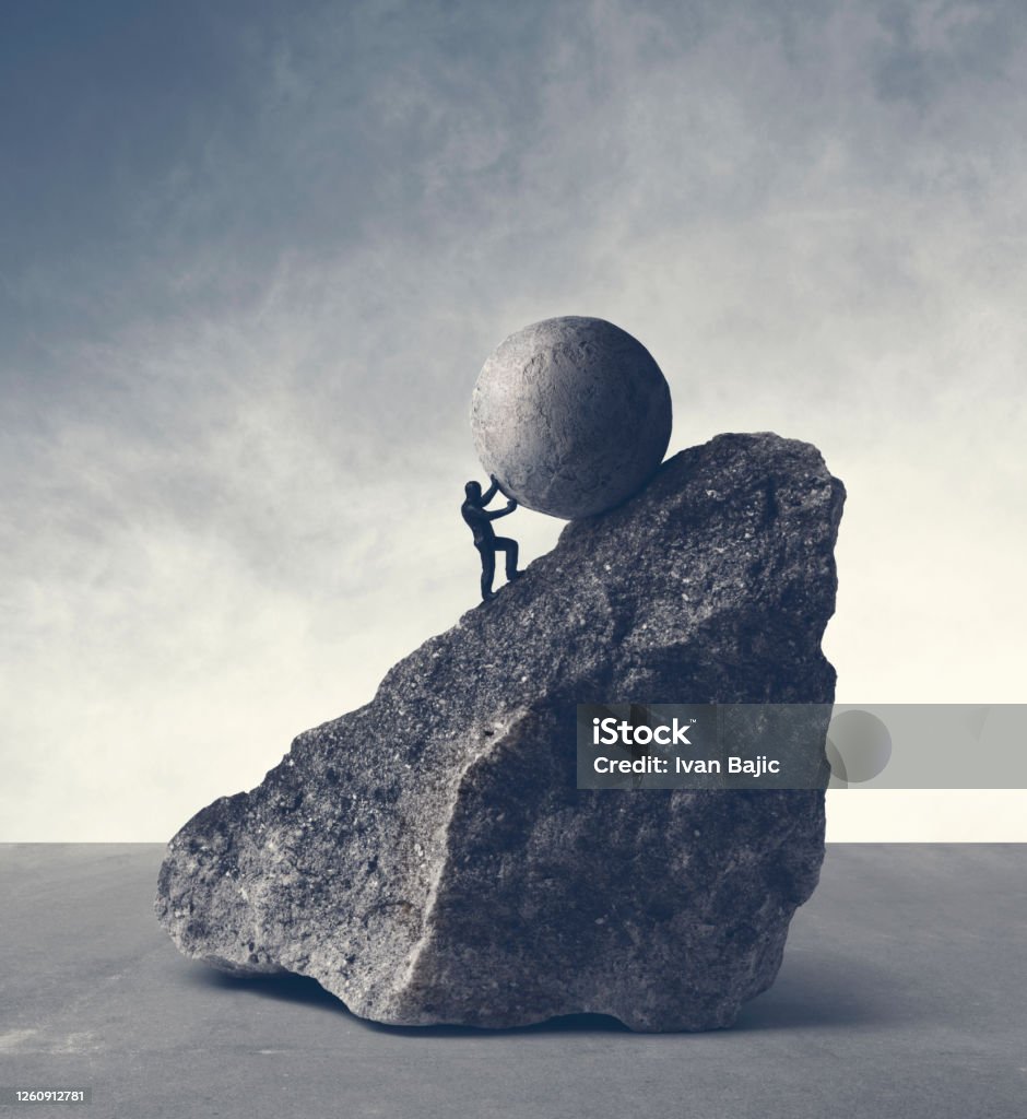 Sisyphean Task Man pushing huge concrete ball up hill. Sisyphus metaphor. Sisyphus Stock Photo