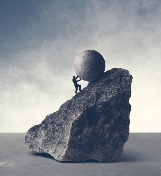 Sisyphean Task Man pushing huge concrete ball up hill. Sisyphus metaphor. sisyphus stock pictures, royalty-free photos & images