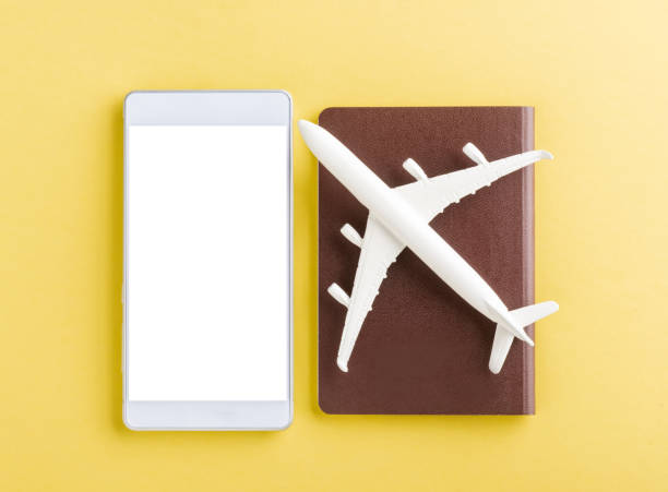 istock minimal toy model plane, airplane on passport and mobile smartphone blank screen 1260950197