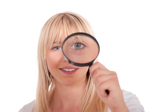 istock young woman with magnifying glass 126103489
