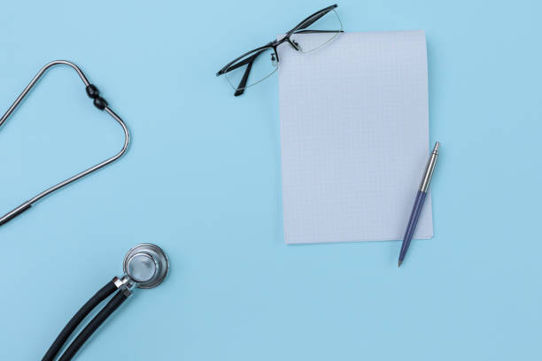 istock Flat lay of basic tools of general practitioners: stethoscope, notebook, pen, mask are on the blue background. 1261048496