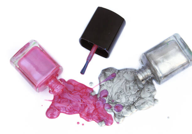 istock Pink and Silver Nail polish Spilled on White 1261049639
